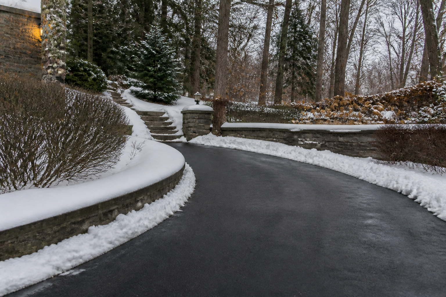 Concept view of a cleared winter driveway in a wooded setting